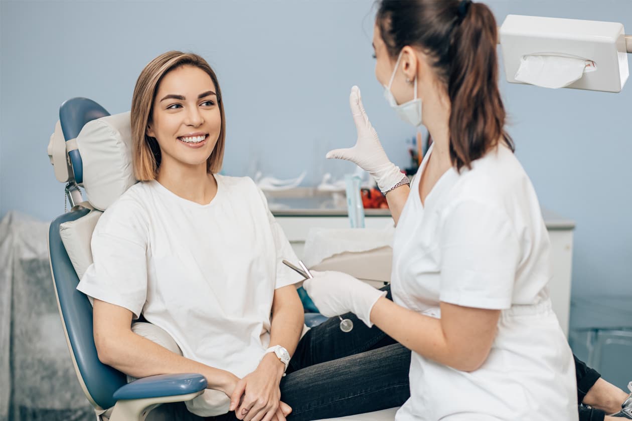Patient smiling with her dental hygienist at Alpine Dental